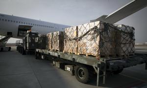 A cargo of high energy biscuits for Ukrainian refugees is offloaded at an airport in Poland.