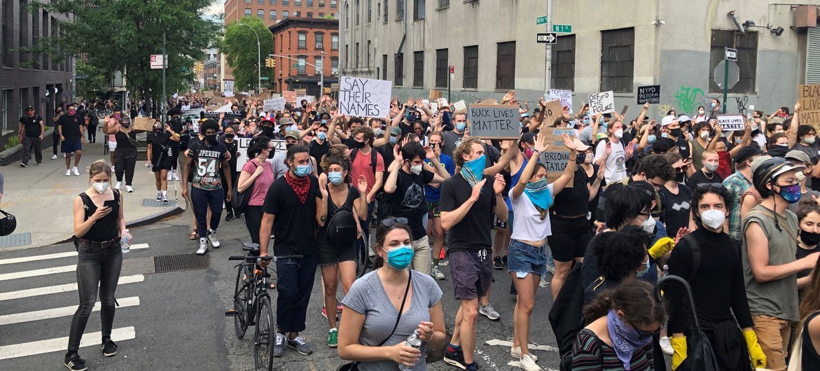 In Brooklyn, New York, protesters peacefully demonstrate against police violence, following the death of George Floyd, in May 2020.. 