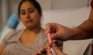A blood glucose test is used to check the level of glucose (sugar) in the blood of a pregnant woman in a hospital in Santiago, Chile.