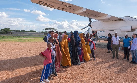 Somali refugees board a flight from Dadaab, Kenya, to Sweden, where they will soon be resettled.