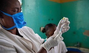 A health worker at a local health centre in Kinshasa, Democratic Republic of the Congo, prepares a vaccine injection.