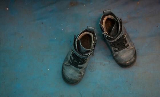 Boy's shoes are shown at the Red Cross tent for mother's and children at Lviv train station in Ukraine.