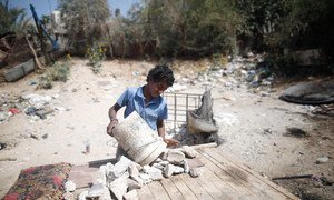 Thirteen-year-old boy in Palestine collects rubble near Gaza City, which he transports by donkey to the market to sell. (file)