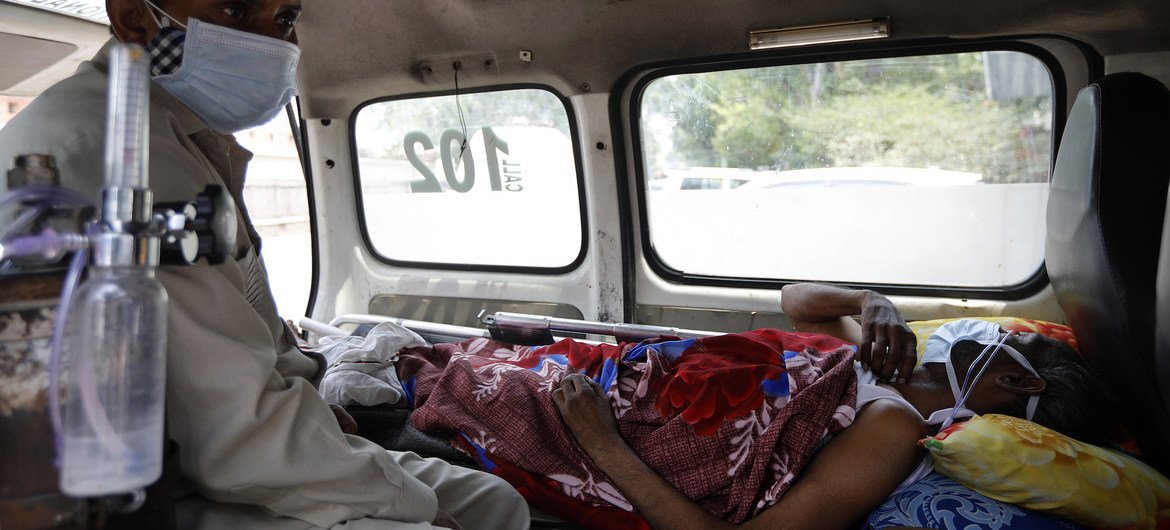 A COVID-19 patient waits inside an ambulance for a bed at a hospital in New Delhi, India.