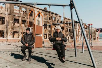 Two 14-year-olds play on the swings at their former school in Kharkiv, northeast Ukraine, after it was destroyed by shelling.