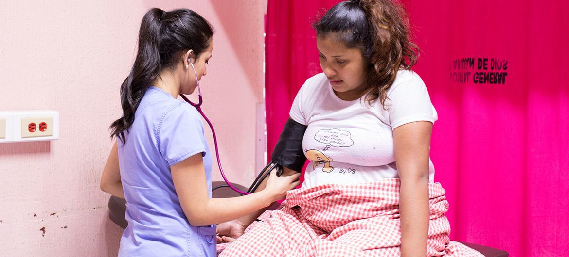 In Guatemala, a nurse monitors a 16-year-old girl who has gone into labour.