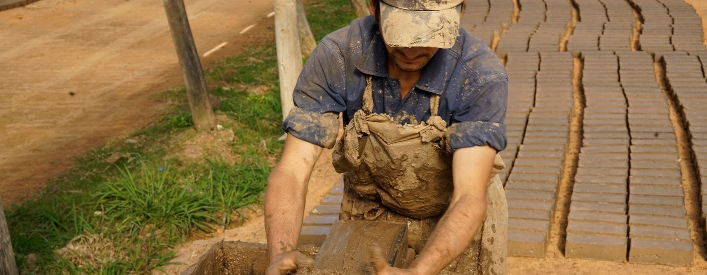 Artisanal brickmakers in Uruguay put the raw material into a mold, and then lay it out to dry.