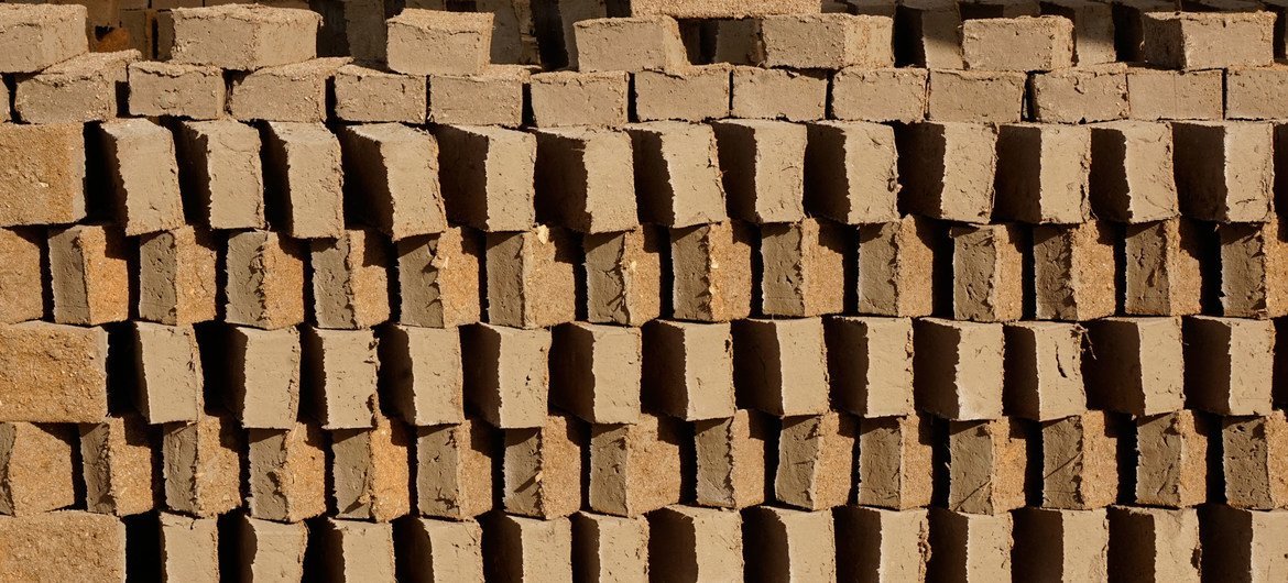 Artisanal brickmakers in Uruguay put the raw material into a mold, and then lay it out to dry.