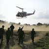 UN peacekeepers fly into a town to perform emergency surgery on wounded Haitian police officers.