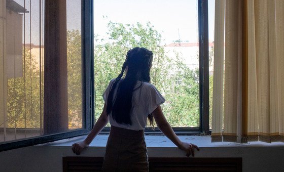 A 14-year-old girl looks out the window, in Kyzylorda, Kazakhstan. Recently, she has addressed feelings of stress and anxiety with the help of an educational psychologist. 