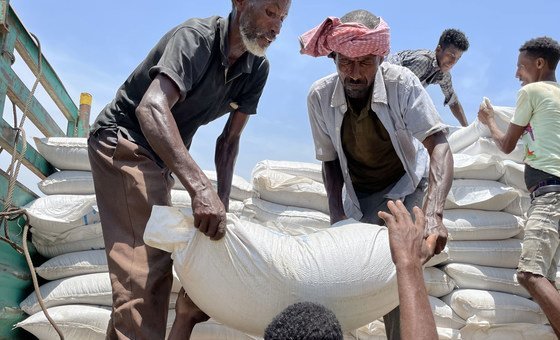Food is unloaded from a truck at a WFP distribution site in Zelazle in the north of Tigray. 