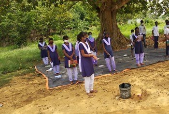 Students in India practice safe handwashing before an open-air class as a precaution against COVID-19. 