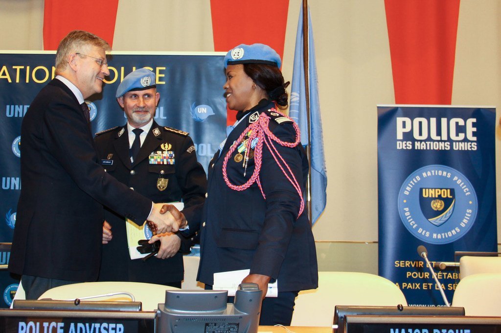 Police Commissioner Luis Carrilho looks on as UN Under-Secretary-General for Peacekeeping Operations, Jean-Pierre Lacroix, shakes the hand of Major Seynabou Diouf, UN Female Police Officer of the Year. (5 November 2019)