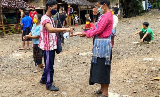 Myanmar refugees share hand sanitiser at Mae Ra Ma Luang temporary shelter in Thailand.