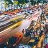 A time-lapsed scene of a busy street at night in Bangkok, Thailand.