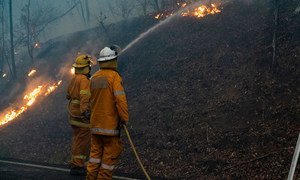 Firefighters in Queensland, Australia, tackle a blaze which is threatening local communities.