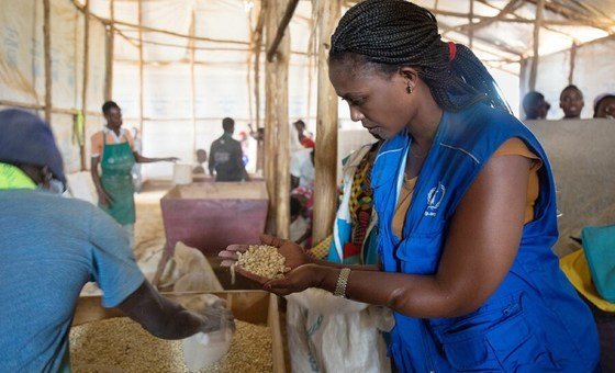 WFP's Liberee Kayumba checks food rations at  Mahama Camp in Rwanda.