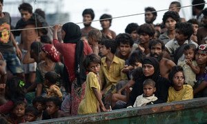 Stranded Rohingya people sit on the deck of an abandoned smugglers’ boat drifting in the Andaman Sea in  2015.