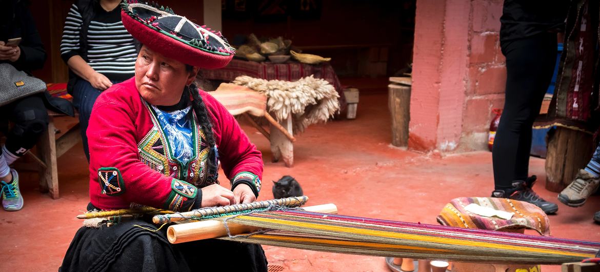A woman weaving in the streets of Chinchero district, Peru.