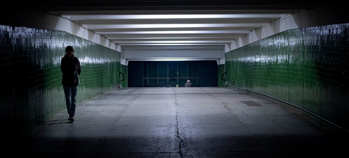 Una mujer camina a través de un túnel en una estación de metro en Kharkiv en Ucrania, donde las personas se refugian para protegerse del conflicto de arriba.