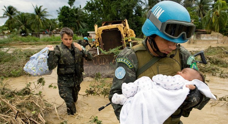 A Brazilian UN peacekeeper rescues a child after parts of the capital of Haiti, Port-au-Prince were flooded during a tropical storm in 2007.