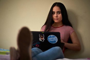 Venezuelan refugee Emily uses her laptop at home in the Ecuadorian capital, Quito. 