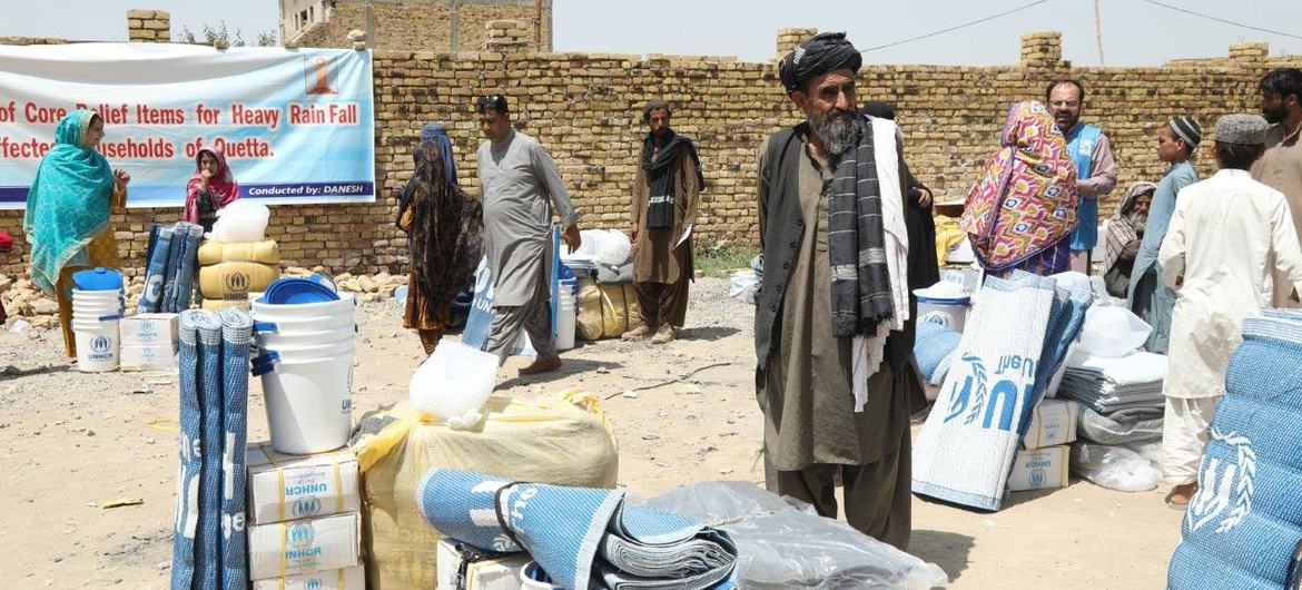 Flood victims collect emergency supplies in Balochistan Province, south-western Pakistan.