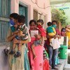 Parents and caregivers line up with their children at an immunization centre in Janakpur, southern Nepal.