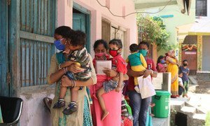 Parents and caregivers line up with their children at an immunization centre in Janakpur, southern Nepal.