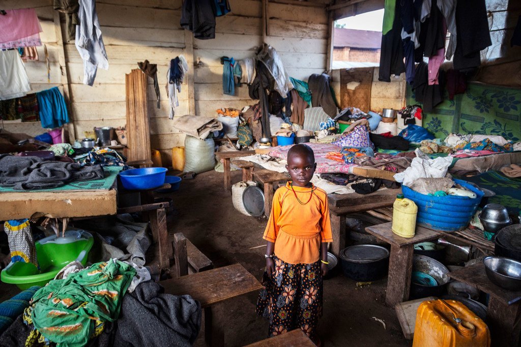 A six-year-old girl stands in a classroom taken over by internally displaced persons for use as a shelter in Ituri, DR Congo.