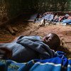 A five-year-old girl sleeps on the brick floor of a colonial era building taken over by displaced families in the Izinga camp in Boga, DR Congo.