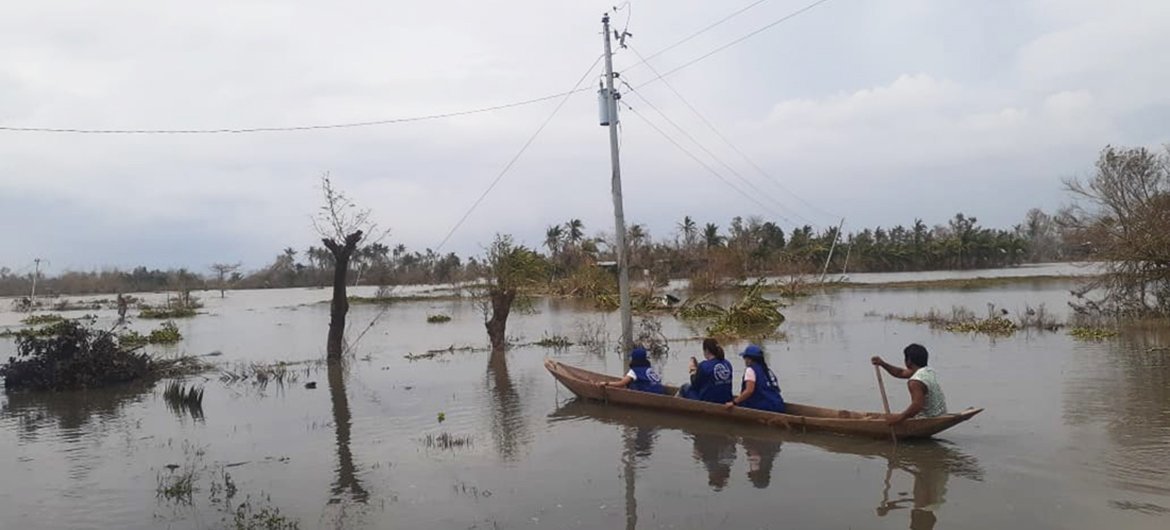 An IOM team on the ground in Camarines Sur, one of the regions badly hit by Typhoon Goni (locally known as Rolly). With transport links damaged, the team uses a boat to reach the affected areas.