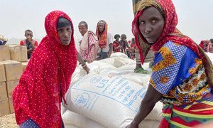 Women in the Afar region of Ethiopia receive emergency food assistance.