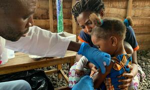 A health worker administers a vaccination against measles on a young girl in the Democratic Republic of the Congo.