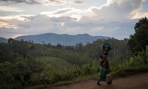 A woman, carrying her child, walks back to her home from the fields in DR Congo’s North Kivu province. The situation in the region remains highly volatile, with civilians bearing the brunt of armed group violence. (file photo)