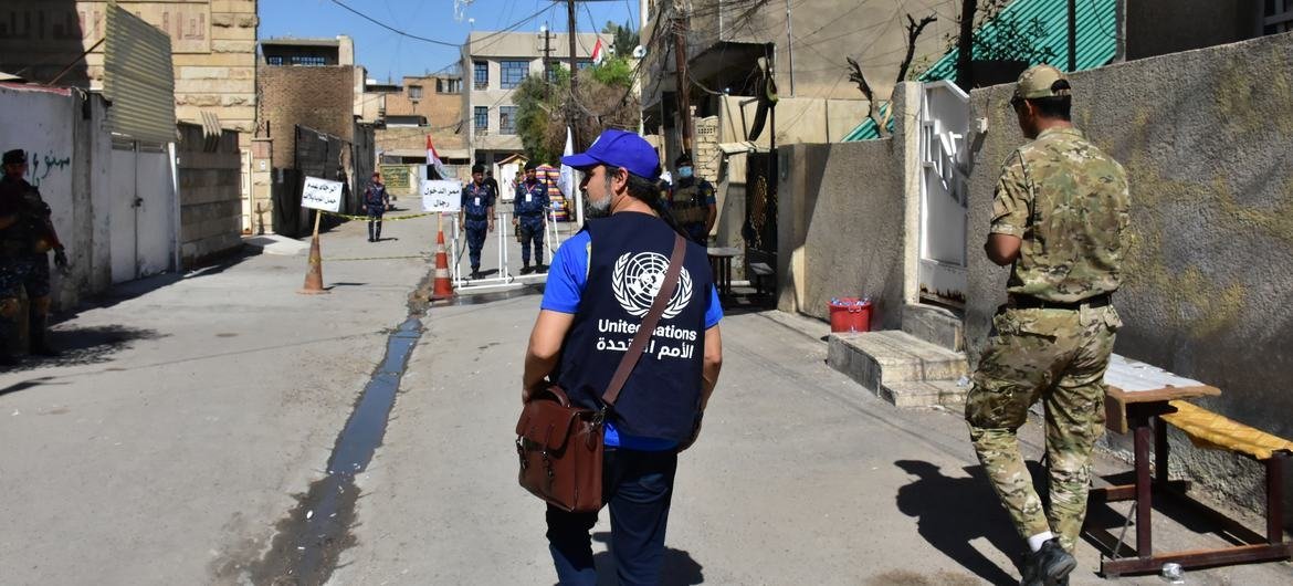 United Nations staff member Brenden Varma looks on as Iraqis vote in Baghdad on Election Day, 10 October 2021.