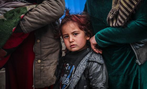 Internally displaced mothers with their children queuing in front of a mobile clinic in Hasakah city in northeast Syria.