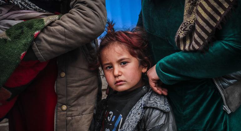 Internally displaced mothers with their children queuing in front of a mobile clinic in Hasakah city in northeast Syria.