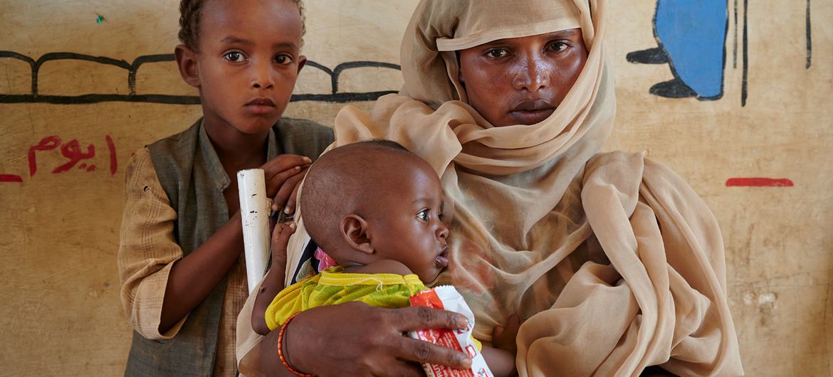 Children in Sudan receive a peanut-based paste for treatment of malnutrition.