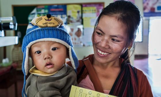 A mother and child after a vaccination session at the Mahosot hospital in Cambodia.