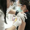 Health workers receive the COVID-19 vaccine in San Juan City, Metro Manila.
