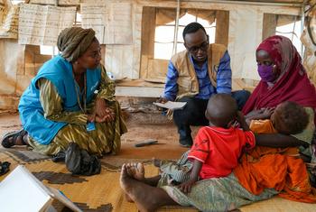 Rania Dagash, UNICEF Deputy Regional Director for Eastern and Southern Africa, (left) meets with a mother and her twins, who are suffering from malnutrition, at a health centre in Dollow, Somalia.