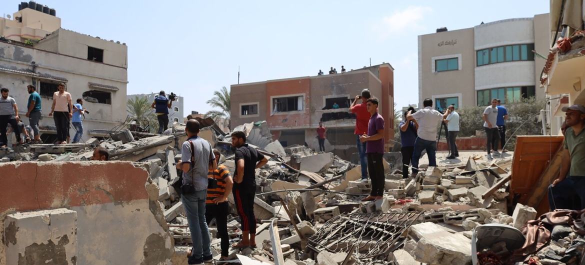 Palestinians survey the aftermath destruction after a bomb hit Gaza over the weekend. 