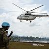 أحد أفراد قوات حفظ السلام يحرس المنطقة حيث تقوم طائرة هليكوبتر تابعة للأمم المتحدة بإيصال المساعدات في إيتوري