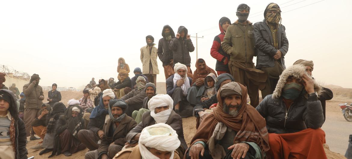 People wait for food distribution in a remote district of Herat province, Afghanistan.