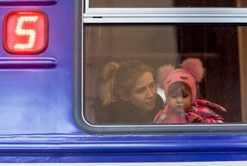 On 5 March 2022, a girl looks out from a window as she waits inside an evacuation train to Przemysl in Poland, at Lviv train station, western Ukraine.