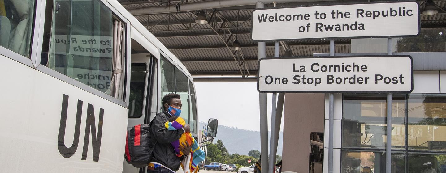 Jean-Nepo Mukeshimana arrives at the border of DRC and Rwanda holding his one month old baby Uwase Josiane.