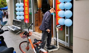 A resident weighing himself on a scale outside a drug store. in Wuhan, China, on April 8, when the lockdown of the city was ended after 76 days. Scales outside drug stores are pretty common in China.