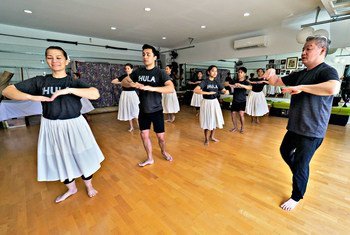 Michael Pili Pang (right) runs a hula dance school in Honolulu, Hawaii