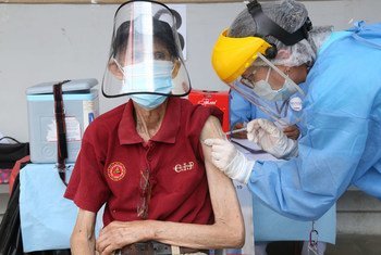 An older man in Peru receives a COVID-19 vaccination.